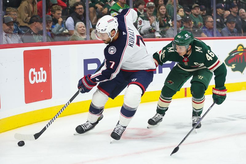 Oct 10, 2024; Saint Paul, Minnesota, USA; Columbus Blue Jackets center Sean Kuraly (7) and Minnesota Wild defenseman Jared Spurgeon (46) compete for the puck during the first period at Xcel Energy Center. Mandatory Credit: Matt Krohn-Imagn Images