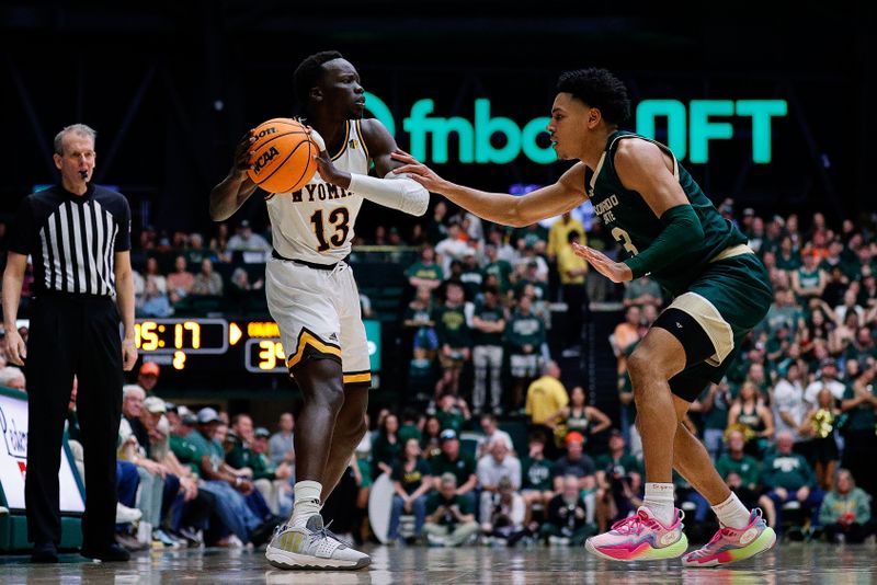 Mar 2, 2024; Fort Collins, Colorado, USA; Wyoming Cowboys guard Akuel Kot (13) controls the ball as Colorado State Rams guard Josiah Strong (3) guards in the second half at Moby Arena. Mandatory Credit: Isaiah J. Downing-USA TODAY Sports