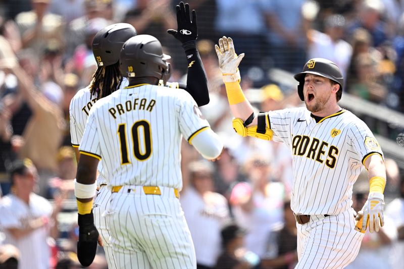 May 1, 2024; San Diego, California, USA; San Diego Padres first baseman Jake Cronenworth (right) is congratulated by right fielder Fernando Tatis Jr. (23) and left fielder Jurickson Profar (10) after hitting a grand slam home run against the Cincinnati Reds during the seventh inning at Petco Park. Mandatory Credit: Orlando Ramirez-USA TODAY Sports