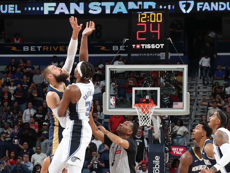 NEW ORLEANS, LA - APRIL 3:  Jonas Valanciunas #17 of the New Orleans Pelicans and Wendell Carter Jr. #34 of the Orlando Magic go up for the opening tip off on April 3, 2024 at the Smoothie King Center in New Orleans, Louisiana. NOTE TO USER: User expressly acknowledges and agrees that, by downloading and or using this Photograph, user is consenting to the terms and conditions of the Getty Images License Agreement. Mandatory Copyright Notice: Copyright 2024 NBAE (Photo by Layne Murdoch Jr./NBAE via Getty Images)