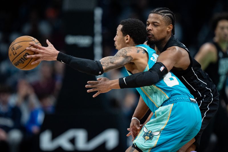 CHARLOTTE, NORTH CAROLINA - MARCH 09: Dennis Smith Jr. #4 of the Brooklyn Nets tries to knock the ball away from Nick Smith Jr. #8 of the Charlotte Hornets in the second quarter during their game at Spectrum Center on March 09, 2024 in Charlotte, North Carolina. NOTE TO USER: User expressly acknowledges and agrees that, by downloading and or using this photograph, User is consenting to the terms and conditions of the Getty Images License Agreement. (Photo by Jacob Kupferman/Getty Images)