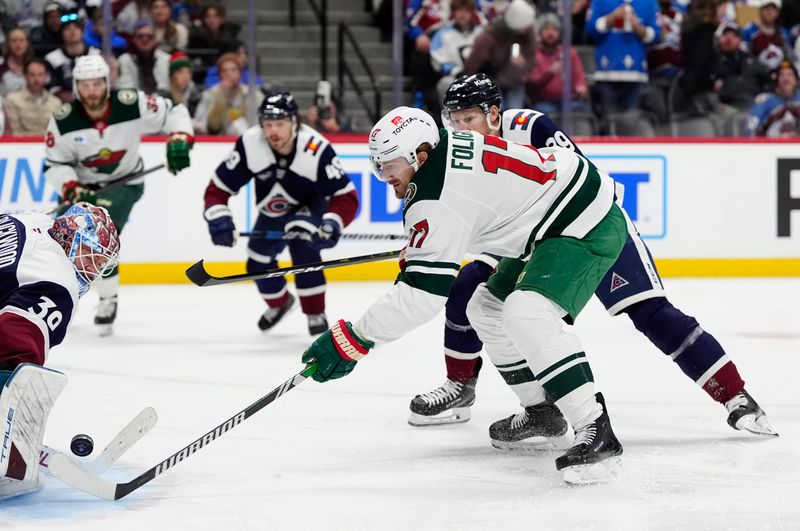 Jan 20, 2025; Denver, Colorado, USA; Colorado Avalanche goaltender Mackenzie Blackwood (39) and center Nathan MacKinnon (29) defend on Minnesota Wild left wing Marcus Foligno (17) in the first period at Ball Arena. Mandatory Credit: Ron Chenoy-Imagn Images