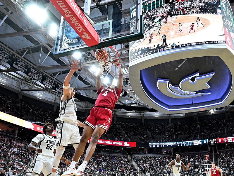 Jan 13, 2026; East Lansing, Michigan, USA;  Indiana Hoosiers forward Sam Alexis (4) dunks the ball against Michigan State Spartans forward Jaxon Kohler (0) during the first half at Jack Breslin Student Events Center. Mandatory Credit: Dale Young-Imagn Images