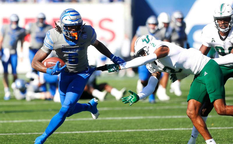 Nov 4, 2023; Memphis, Tennessee, USA;  Memphis Tigers  Sutton Smith (5) rushes the ball against South Florida s Braxton Clark (2) at Simmons Bank Liberty Stadium. Mandatory Credit: Stu Boyd II-USA TODAY Sports