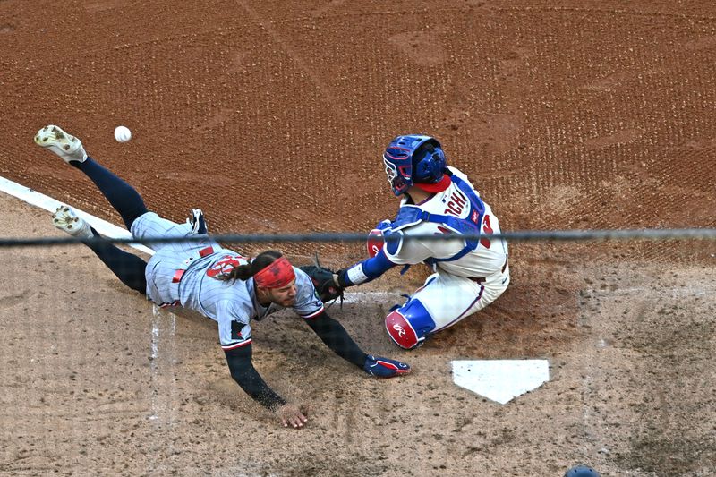 Sep 28, 2025; Philadelphia, Pennsylvania, USA; Minnesota Twins outfielder Austin Martin (16) slides safely into home ahead of tag by Philadelphia Phillies catcher Rafael Marchán (13) during the sixth inning at Citizens Bank Park. Mandatory Credit: Eric Hartline-Imagn Images