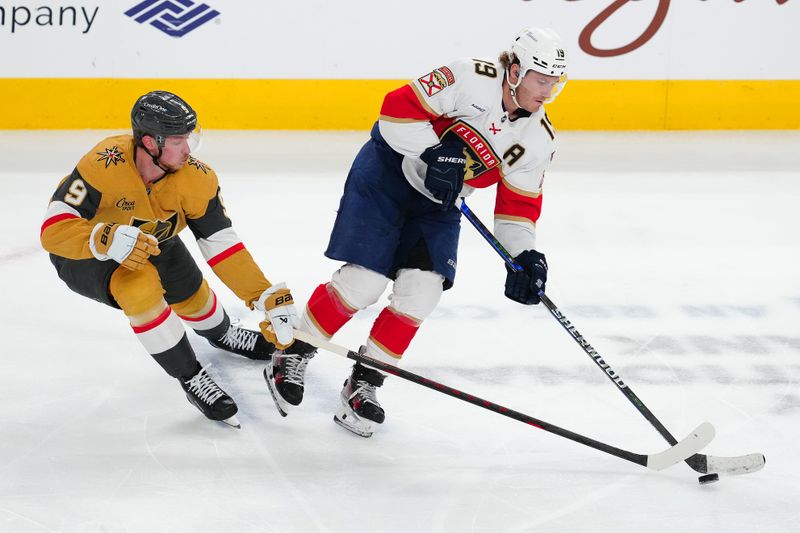 Jan 26, 2025; Las Vegas, Nevada, USA; Florida Panthers left wing Matthew Tkachuk (19) keeps the puck away from Vegas Golden Knights center Jack Eichel (9) during the third period at T-Mobile Arena. Mandatory Credit: Stephen R. Sylvanie-Imagn Images