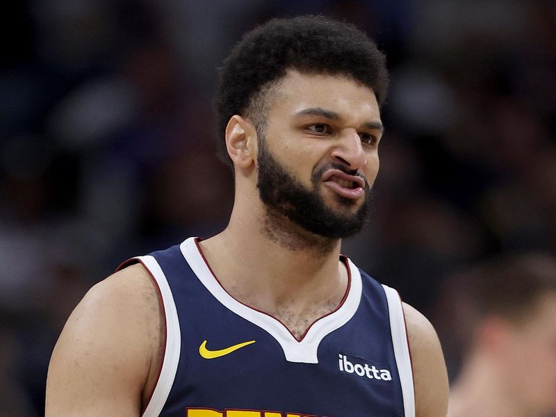 DENVER, COLORADO - DECEMBER 28: Jamal Murray #27 of the Denver Nuggets reacts after a basket against the Memphis Grizzlies in the third quarter at Ball Arena on December 28, 2023 in Denver, Colorado.  NOTE TO USER: User expressly acknowledges and agrees that, by downloading and or using this photograph, User is consenting to the terms and conditions of the Getty Images License Agreement.  (Photo by Matthew Stockman/Getty Images)