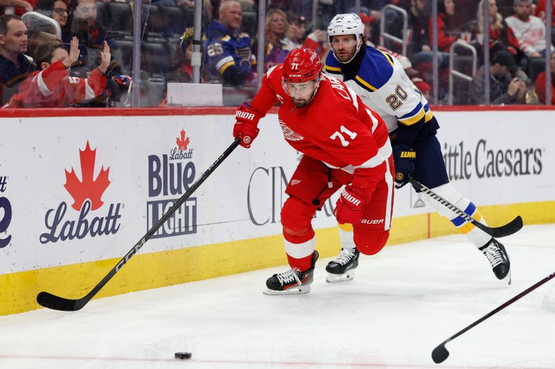 Feb 24, 2024; Detroit, Michigan, USA;  Detroit Red Wings center Dylan Larkin (71) skates with the puck chased by St. Louis Blues left wing Brandon Saad (20) in the second period at Little Caesars Arena. Mandatory Credit: Rick Osentoski-USA TODAY Sports