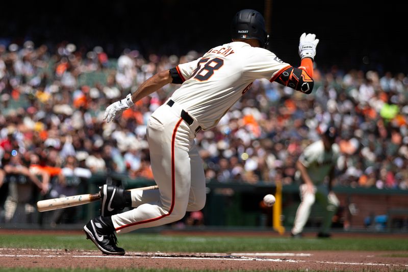 Aug 15, 2024; San Francisco, California, USA; San Francisco Giants center fielder Grant McCray (58) lays down a squeeze bunt against the Atlanta Braves during the second inning at Oracle Park. McCray reached safely for his first major league hit. Mandatory Credit: D. Ross Cameron-USA TODAY Sports