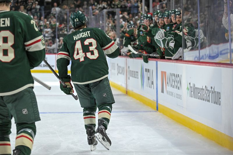Sep 28, 2025; Saint Paul, Minnesota, USA;  Minnesota Wild forward Hunter Haight (43) heads to the bench to celebrate his goal against the Chicago Blackhawks during the second period at Xcel Energy Center. Mandatory Credit: Nick Wosika-Imagn Images
