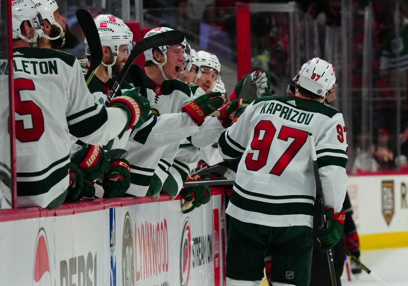 Jan 21, 2024; Raleigh, North Carolina, USA;  Minnesota Wild left wing Kirill Kaprizov (97) celebrates his empty net goal against the Carolina Hurricanes during the third periodat PNC Arena. Mandatory Credit: James Guillory-USA TODAY Sports