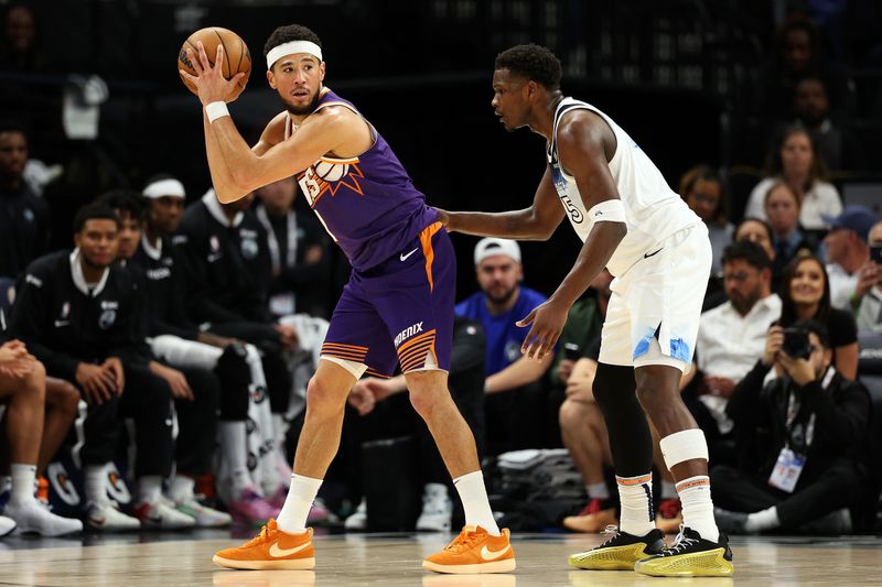 MINNEAPOLIS, MINNESOTA - NOVEMBER 17: Devin Booker #1 of the Phoenix Suns handles the ball against Anthony Edwards #5 of the Minnesota Timberwolves in the first quarter of the game at Target Center on November 17, 2024 in Minneapolis, Minnesota. NOTE TO USER: User expressly acknowledges and agrees that, by downloading and or using this photograph, User is consenting to the terms and conditions of the Getty Images License Agreement. (Photo by David Berding/Getty Images)