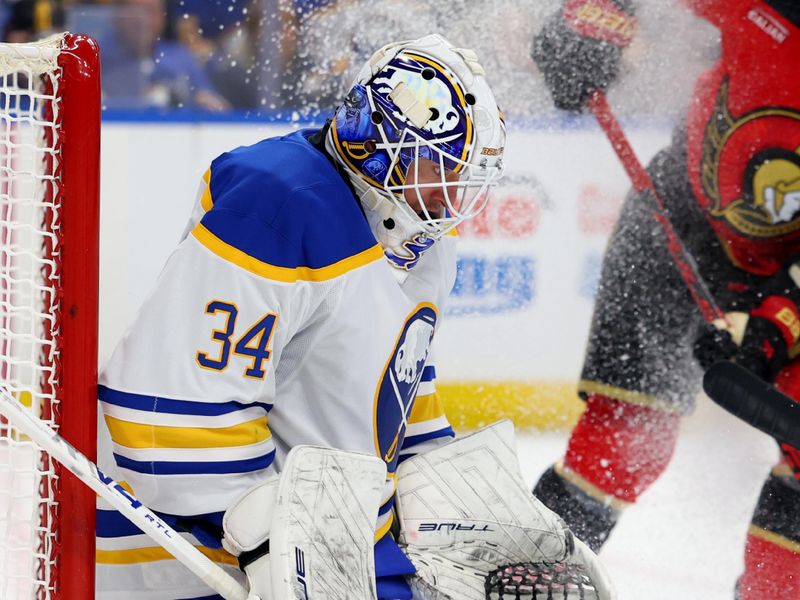 Oct 15, 2025; Buffalo, New York, USA;  Buffalo Sabres goaltender Alex Lyon (34) makes a save during the third period against the Ottawa Senators at KeyBank Center. Mandatory Credit: Timothy T. Ludwig-Imagn Images