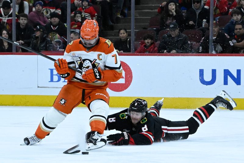 Nov 30, 2025; Chicago, Illinois, USA;  Anaheim Ducks defenseman Radko Gudas (7) and Chicago Blackhawks center Ryan Donato (8) chase the puck during the first period at United Center. Mandatory Credit: Matt Marton-Imagn Images