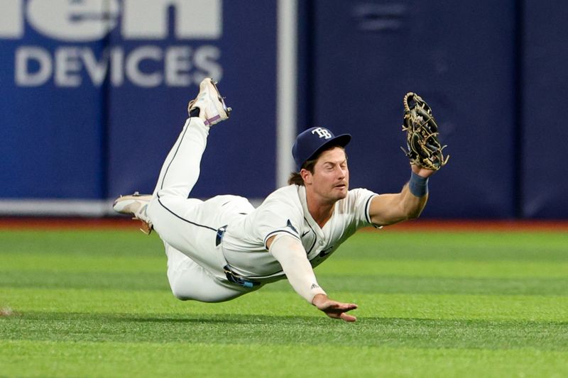 Jul 11, 2024; St. Petersburg, Florida, USA; Tampa Bay Rays outfielder Jonny DeLuca (21) makes a diving catch against the New York Yankees in the sixth inning at Tropicana Field. Mandatory Credit: Nathan Ray Seebeck-USA TODAY Sports