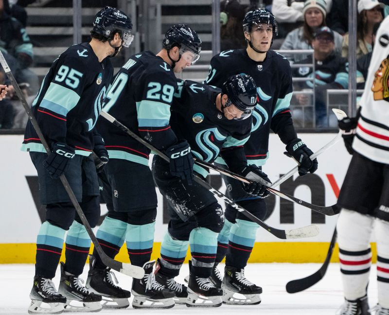 Jan 24, 2024; Seattle, Washington, USA; Seattle Kraken forward Jaden Schwartz (17), second from right, is helped to the bench by forward Alex Wennberg (21), right, forward Andre Burakovsky (95) and defenseman Vince Dunn (29) during the second period at Climate Pledge Arena. Mandatory Credit: Stephen Brashear-USA TODAY Sports