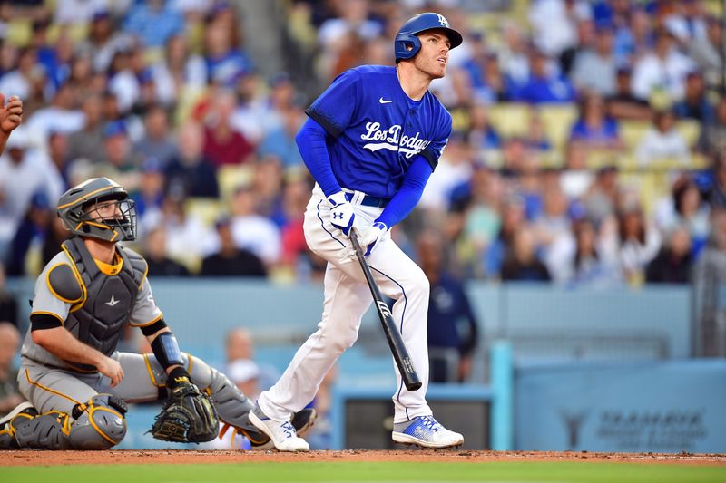 Jul 6, 2023; Los Angeles, California, USA; Los Angeles Dodgers first baseman Freddie Freeman (5) hits a two run home run against the Pittsburgh Pirates during the first inning at Dodger Stadium. Mandatory Credit: Gary A. Vasquez-USA TODAY Sports