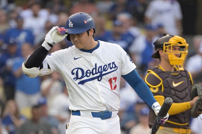Oct 11, 2024; Los Angeles, California, USA; Los Angeles Dodgers designated hitter Shohei Ohtani (17) reacts at bat in the first inning against the San Diego Padres during game five of the NLDS for the 2024 MLB Playoffs at Dodger Stadium. Mandatory Credit: Jayne Kamin-Oncea-Imagn Images