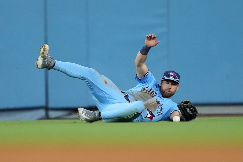 Jul 25, 2023; Los Angeles, California, USA; Toronto Blue Jays center fielder Kevin Kiermaier (39) attempts to catch the ball against the Los Angeles Dodgers at Dodger Stadium. Mandatory Credit: Kirby Lee-USA TODAY Sports