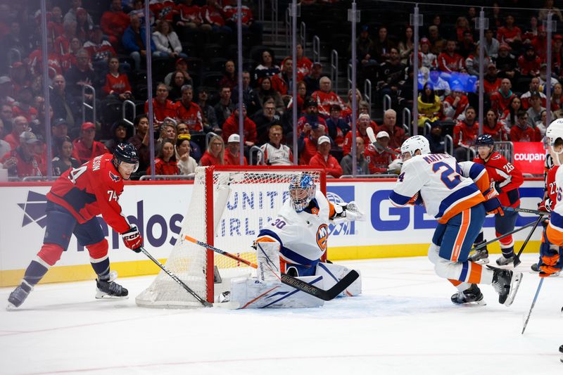 Oct 31, 2025; Washington, District of Columbia, USA; Washington Capitals defenseman John Carlson (74) shoots the puck on New York Islanders goaltender Ilya Sorokin (30) during the first period at Capital One Arena. Mandatory Credit: Geoff Burke-Imagn Images