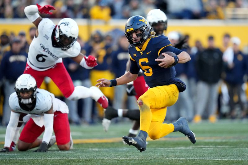 Nov 18, 2023; Morgantown, West Virginia, USA; West Virginia Mountaineers quarterback Garrett Greene (6) carries the ball on a touchdown run against the Cincinnati Bearcats in the third quarter at Milan Puskar Stadium. West Virginia won 42-21. Mandatory Credit: Kareem Elgazzar-USA TODAY Sports