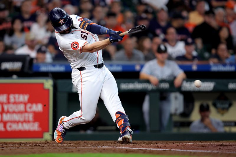 Aug 18, 2024; Houston, Texas, USA; Houston Astros left fielder Chas McCormick (20) hits an infield single against the Chicago White Sox during the third inning at Minute Maid Park. Mandatory Credit: Erik Williams-USA TODAY Sports