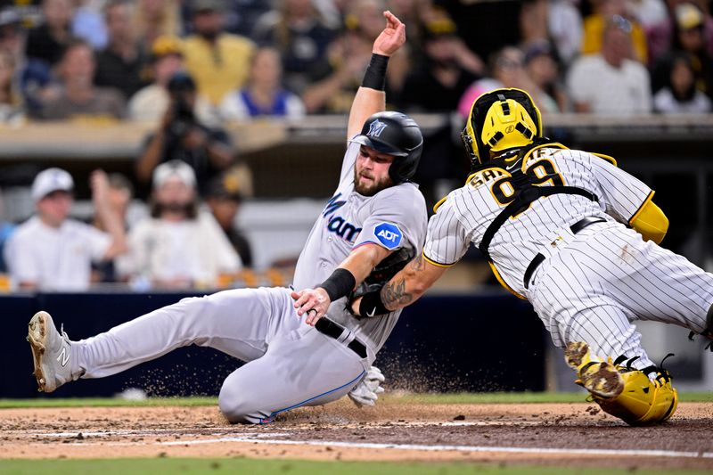 Aug 22, 2023; San Diego, California, USA; San Diego Padres catcher Gary Sanchez (99) tags out Miami Marlins third baseman Jake Burger (36) at home plate during the third inning at Petco Park. Mandatory Credit: Orlando Ramirez-USA TODAY Sports