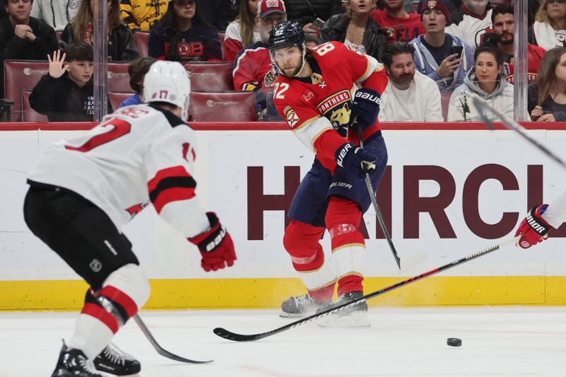 Jan 13, 2024; Sunrise, Florida, USA; Florida Panthers center Kevin Stenlund (82) passes the puck against the New Jersey Devils during the second period at Amerant Bank Arena. Mandatory Credit: Sam Navarro-USA TODAY Sports