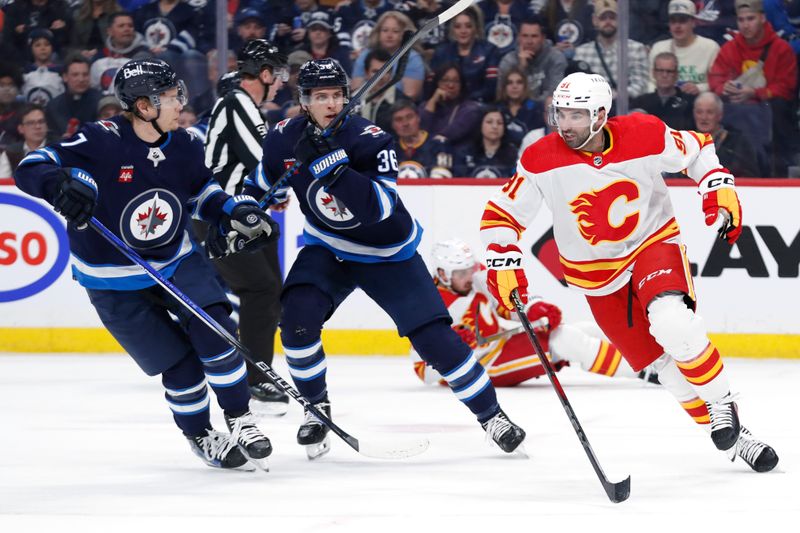 Apr 4, 2024; Winnipeg, Manitoba, CAN; Calgary Flames center Nazem Kadri (91) skates up the ice to Winnipeg Jets center Vladislav Namestnikov (7) in the second period at Canada Life Centre. Mandatory Credit: James Carey Lauder-USA TODAY Sports