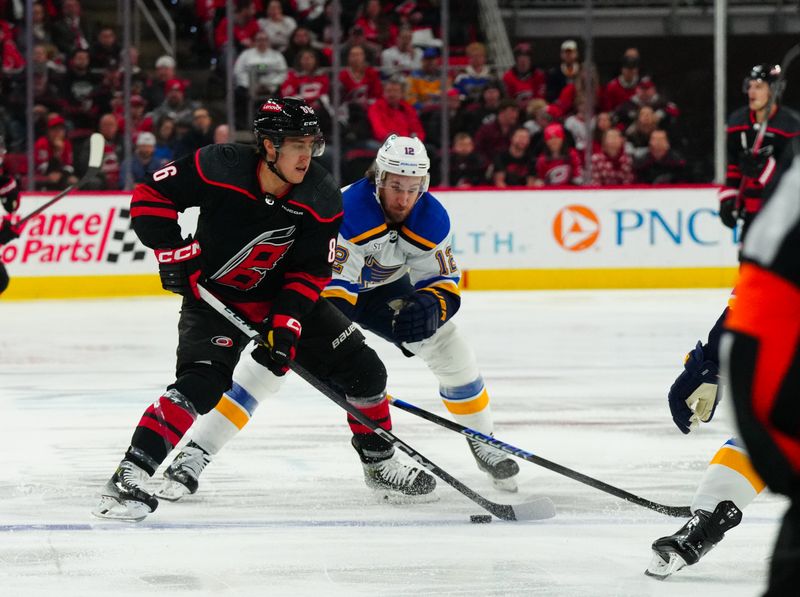 Jan 6, 2024; Raleigh, North Carolina, USA; Carolina Hurricanes left wing Teuvo Teravainen (86) skates with the puck against St. Louis Blues right wing Kevin Hayes (12) during the first period at PNC Arena. Mandatory Credit: James Guillory-USA TODAY Sports