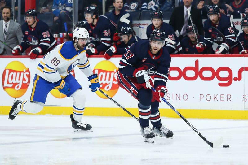 Jan 26, 2023; Winnipeg, Manitoba, CAN;  Winnipeg Jets forward Adam Lowry (17) skates away from Buffalo Sabres forward Alex Tuch (89) during the second period at Canada Life Centre. Mandatory Credit: Terrence Lee-USA TODAY Sports