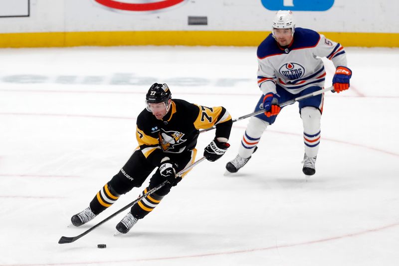 Mar 10, 2024; Pittsburgh, Pennsylvania, USA;  Pittsburgh Penguins center Jeff Carter (77) moves the puck ahead of Edmonton Oilers defenseman Cody Ceci (5) during the third period at PPG Paints Arena. The Oilers won 4-0. Mandatory Credit: Charles LeClaire-USA TODAY Sports