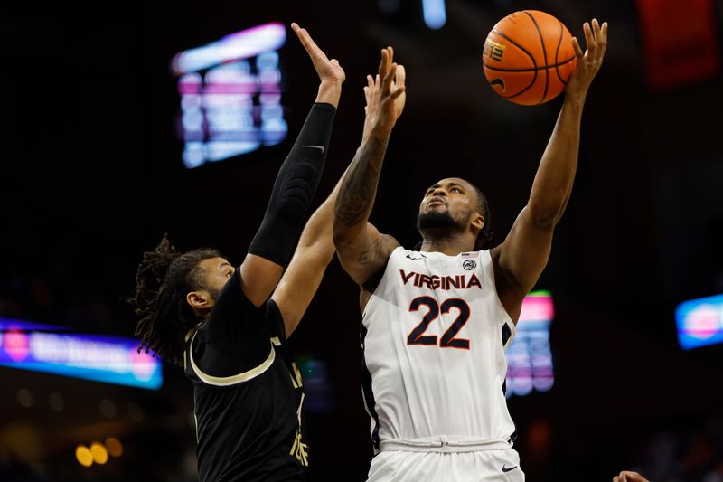 Feb 17, 2024; Charlottesville, Virginia, USA; Virginia Cavaliers forward Jordan Minor (22) is fouled while shooting by Wake Forest Demon Deacons forward Efton Reid III (4) in the second half at John Paul Jones Arena. Mandatory Credit: Geoff Burke-USA TODAY Sports