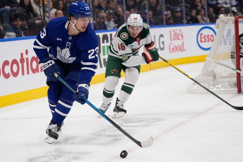 Jan 19, 2026; Toronto, Ontario, CAN; Toronto Maple Leafs forward Matthew Knies (23) plays the puck against Minnesota Wild defenseman Jared Spurgeon (46) during the first period at Scotiabank Arena. Mandatory Credit: John E. Sokolowski-Imagn Images Jan 19, 2026; Toronto, Ontario, CAN; Toronto Maple Leafs forward Matthew Knies (23) plays the puck against Minnesota Wild defenseman Jared Spurgeon (46) during the first period at Scotiabank Arena. Mandatory Credit: John E. Sokolowski-Imagn Images