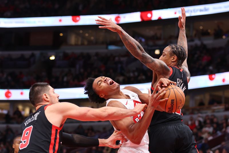 CHICAGO, ILLINOIS - JANUARY 30: Scottie Barnes #4 of the Toronto Raptors is fouled by Nikola Vucevic #9 of the Chicago Bulls during the second half at the United Center on January 30, 2024 in Chicago, Illinois. NOTE TO USER: User expressly acknowledges and agrees that, by downloading and or using this photograph, User is consenting to the terms and conditions of the Getty Images License Agreement.  (Photo by Michael Reaves/Getty Images)