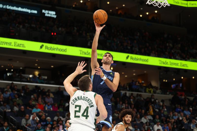 MEMPHIS, TENNESSEE - OCTOBER 31: Santi Aldama #7 of the Memphis Grizzlies shoots the ball over Pat Connaughton #24 of the Milwaukee Bucks during the second quarter at FedExForum on October 31, 2024 in Memphis, Tennessee. NOTE TO USER: User expressly acknowledges and agrees that, by downloading and or using this Photograph, user is consenting to the terms and conditions of the Getty Images License Agreement. (Photo by Wes Hale/Getty Images)