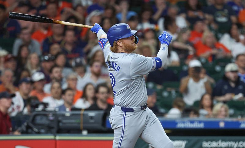 Apr 2, 2024; Houston, Texas, USA; Toronto Blue Jays designated hitter Justin Turner (2) hits a single during the seventh inning against the Houston Astros at Minute Maid Park. Mandatory Credit: Troy Taormina-USA TODAY Sports