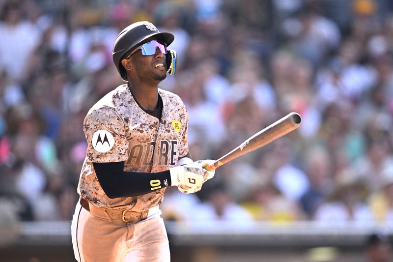 Sep 22, 2024; San Diego, California, USA; San Diego Padres left fielder Jurickson Profar (10) hits a sacrifice fly against the Chicago White Sox during the eighth inning at Petco Park. Mandatory Credit: Orlando Ramirez-Imagn Images