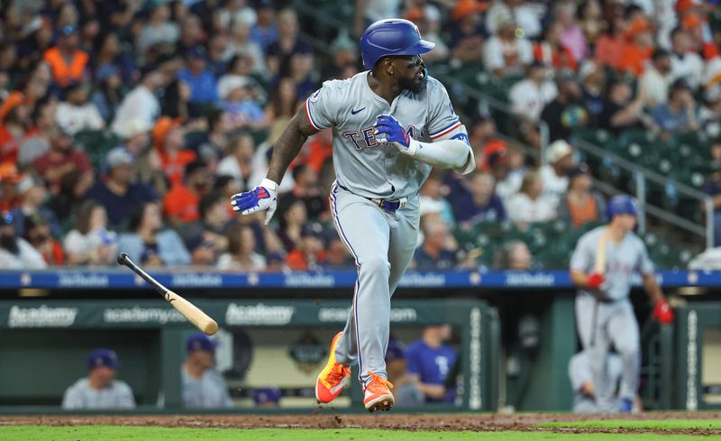 Apr 14, 2024; Houston, Texas, USA; Texas Rangers right fielder Adolis Garcia (53) hits a single during the eighth inning against the Houston Astros at Minute Maid Park. Mandatory Credit: Troy Taormina-USA TODAY Sports