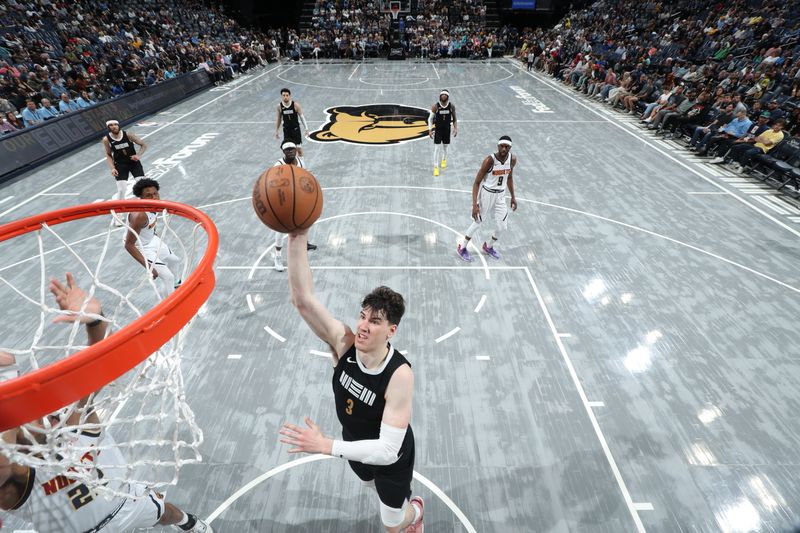 MEMPHIS, TN - APRIL 14:  Jake LaRavia #3 of the Memphis Grizzlies drives to the basket during the game against the Denver Nuggets on April 14, 2024 at FedExForum in Memphis, Tennessee. NOTE TO USER: User expressly acknowledges and agrees that, by downloading and or using this photograph, User is consenting to the terms and conditions of the Getty Images License Agreement. Mandatory Copyright Notice: Copyright 2024 NBAE (Photo by Joe Murphy/NBAE via Getty Images)