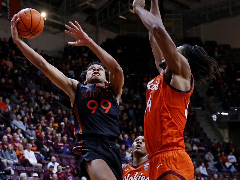 Jan 4, 2025; Blacksburg, Virginia, USA; Miami Hurricanes guard Divine Ugochukwu (99) shoots the ball against Virginia Tech Hokies forward Mylyjael Poteat (34) during the second half at Cassell Coliseum. Mandatory Credit: Peter Casey-Imagn Images