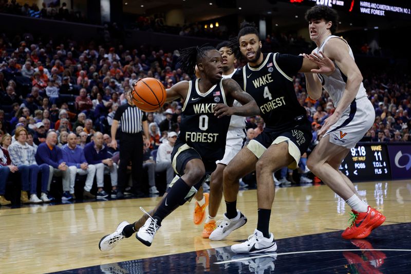 Feb 17, 2024; Charlottesville, Virginia, USA; Wake Forest Demon Deacons guard Kevin Miller (0) drives to the basket as Virginia Cavaliers forward Blake Buchanan (0) defends in the first half at John Paul Jones Arena. Mandatory Credit: Geoff Burke-USA TODAY Sports