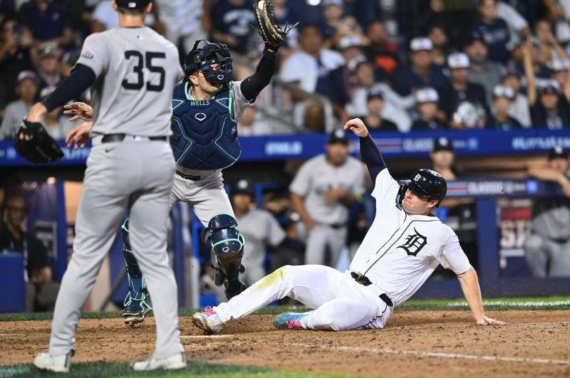 Aug 18, 2024; Williamsport, Pennsylvania, USA; Detroit Tigers infielder Colt Keith (33) slides home to score against New York Yankees catcher Austin Wells (28) in the ninth inning at BB&T Ballpark at Historic Bowman Field. Mandatory Credit: Kyle Ross-USA TODAY Sports