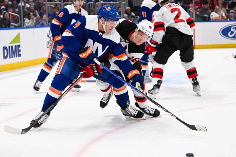 Mar 24, 2024; Elmont, New York, USA;  New York Islanders center Bo Horvat (14) and New Jersey Devils left wing Ondrej Palat (18) battle for the puck during the first period at UBS Arena. Mandatory Credit: Dennis Schneidler-USA TODAY Sports