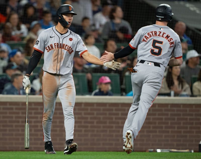 Aug 23, 2024; Seattle, Washington, USA; San Francisco Giants right fielder Mike Yastrzemski (5) is congratulated by centerfielder Grant McCray (58) after scoring a run during the fifth inning against the Seattle Mariners at T-Mobile Park. Mandatory Credit: Stephen Brashear-USA TODAY Sports