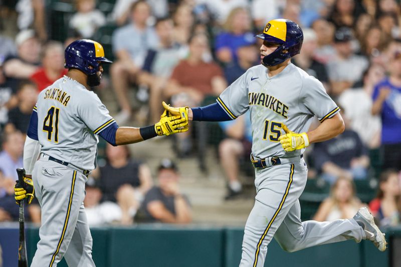 Aug 12, 2023; Chicago, Illinois, USA; Milwaukee Brewers right fielder Tyrone Taylor (15) celebrates with first baseman Carlos Santana (41) after scoring against the Chicago White Sox during the seventh inning at Guaranteed Rate Field. Mandatory Credit: Kamil Krzaczynski-USA TODAY Sports