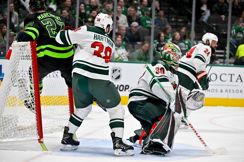 Jan 10, 2024; Dallas, Texas, USA; Minnesota Wild right wing Ryan Hartman (38) checks Dallas Stars left wing Mason Marchment (27) into the net during the second period at the American Airlines Center. Mandatory Credit: Jerome Miron-USA TODAY Sports