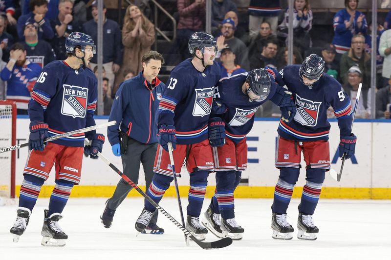 Mar 17, 2024; New York, New York, USA; New York Rangers defenseman Ryan Lindgren (55) is helped off the ice by teammates after an injury during the second period against the New York Islanders at Madison Square Garden. Mandatory Credit: Vincent Carchietta-USA TODAY Sports