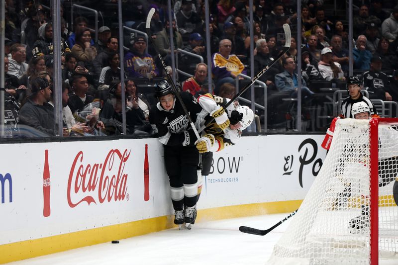 Oct 30, 2024; Los Angeles, California, USA; Los Angeles Kings center Alex Turcotte (15) checks Vegas Golden Knights right wing Alexander Holtz (26) during the second period at Crypto.com Arena. Mandatory Credit: Kiyoshi Mio-Imagn Images