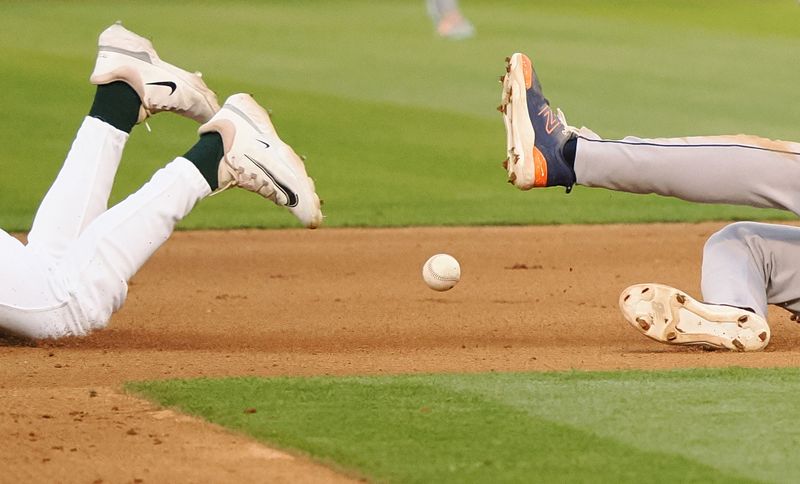 Jul 22, 2024; Oakland, California, USA; The ball between the feet of Oakland Athletics second baseman Zack Gelof (20) and Houston Astros shortstop Jeremy Pena (3) during the fourth inning at Oakland-Alameda County Coliseum. Mandatory Credit: Kelley L Cox-USA TODAY Sports